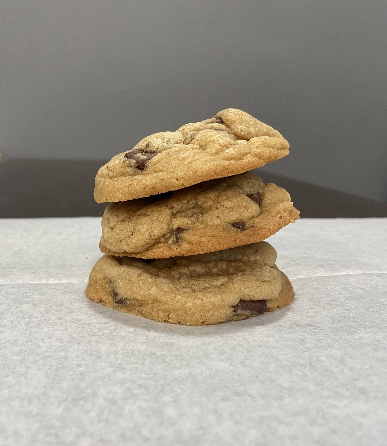 soft and chewy chocolate chunk cookies stacked together, showing golden edges and melted chocolate chunks. 