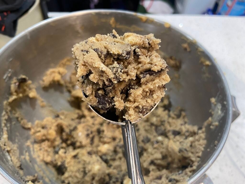 Cookies and cream cookie dough mixed with chopped Oreos and chocolate chips before baking. 