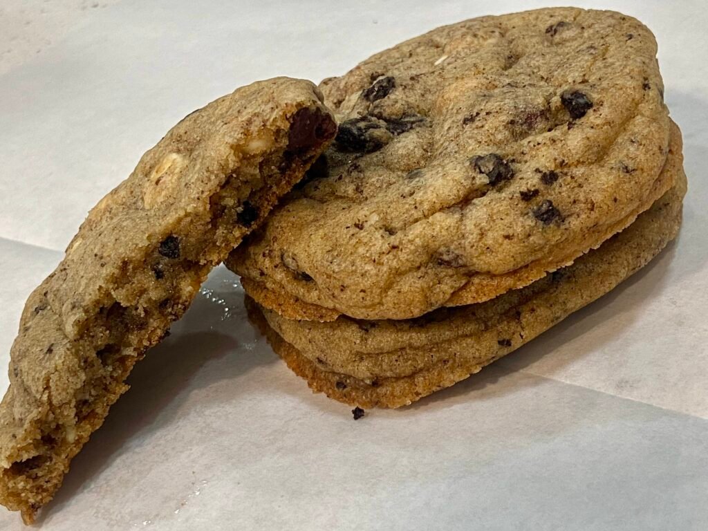 Chewy cookies and cream cookies resting on parchment paper, ready to serve. 