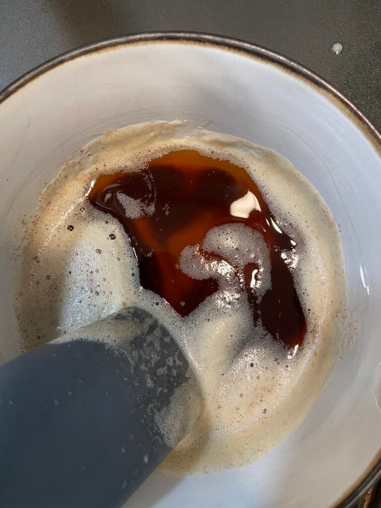 Golden brown butter with toasted milk solids forming at the bottom of the bowl.