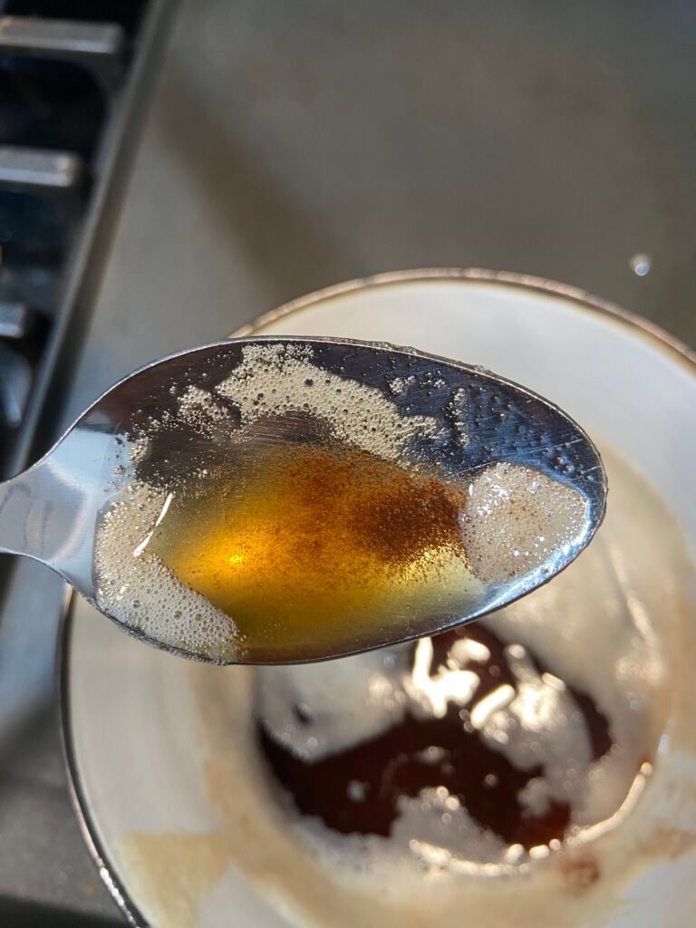 Finished brown butter cooling in a bowl before being used for baking.